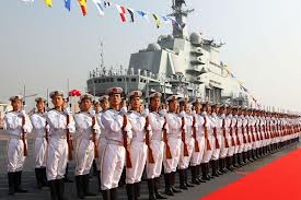 Chinese Sailors military review on the flight deck of a new Chinese carrier.