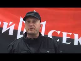 Yarosh in front of Right Sector flag.