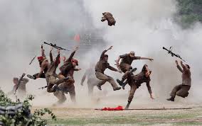 South Korean soldiers hamming it up in mock battle, costumed in North Korean uniforms.