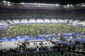 Crowds of soccer fans gather on the field of the Stade de Paris waiting for security to give them the "all clear."