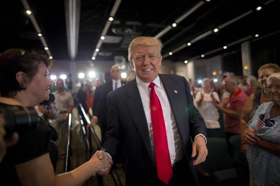 TrumpWalkingPastShakesHandTeethGritGrin