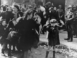 A Jewish child with family being taken prisoner in the Warsaw Ghetto Uprising 1944 by Nazi German soldiers.