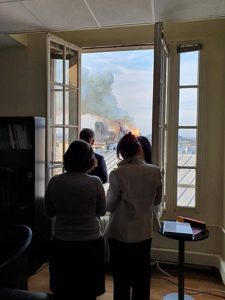 French Government workers peer out their office window at the fire.