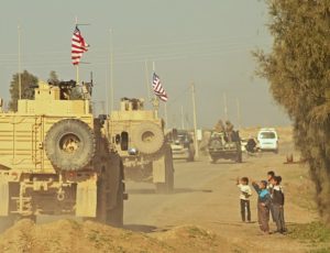 US armored personnel carriers in retreat south from the Turkish-Syrian border.