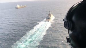 Venezuelan Navy helicopter and frigate escorting the first of a fleet of Iranian tankers into port.