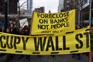 Occupy Bank of America March 15, 2012, Occupy Wall Street targets Bank of America with a rally and march. Activists “moved in” to a branch by setting up a sidewalk living room on the theory that ‘the bank took our homes so we're moving in with them.’ A half dozen people were arrested. Photo: Mike Fleshman, © Creative Commons. 