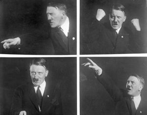 Hitler rehearsing gestures for his public speaking, photographed by Heinrich Hoffmann, playing Nazi Prophet. Source: Bundesarchiv_Bild_102-10460, Adolf_Hitler, PhotosHoffmann, Heinrich, © Creative Commons.