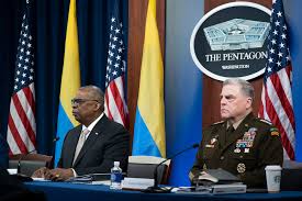 Pentagon chief Lloyd Austin and head of the Joint Chiefs of Staff General Mark Milley do a virtual meeting with Ukrainian leaders in late May 2022. The depth of American knowledge does not include presenting Ukrainian flags right-side up.