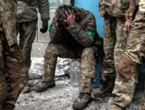A Ukrainian soldier in despair of the massacre offensive going on. His armband is bright green, that means he's a member of many "territorial" guard units, the least trained for grappling with the Russian superpower's well trained and armed forces. They are waging a Ukrainian "turkey-shoot" sad to say. And it has only one end in the next few months, complete defeat of Ukrainian force of arms. 