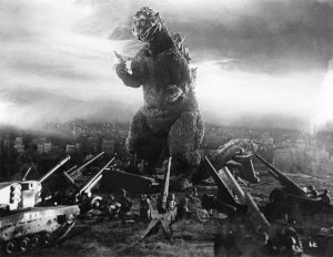 “Put! The jet! DOWN!!!” Production still of either Haruo Nakajima or Katsumi Tezuka portraying Godzilla via suitmation in Godzilla (1954), Toho Productions. Public domain. 